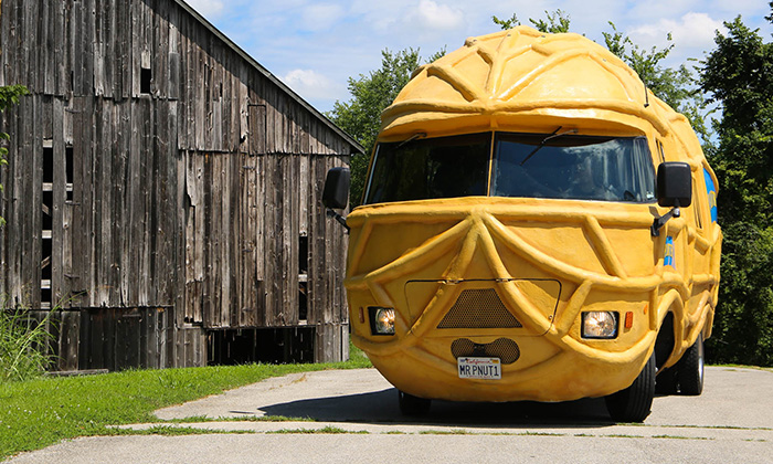 the Nutmobile parked on a dirt road outside of a rustic barn